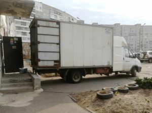 Погрузка мебели в грузовой автомобиль возле жилого дома — Азбука переезда